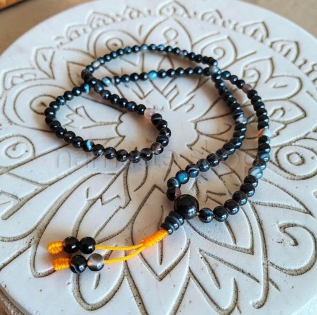 Mala di perle nere su mandala — corona sacra di 108 grani